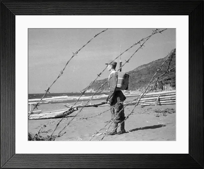 Framed Print : Soldier Standing Alone Near Fence Framed Print : Soldier Standing Alone Near Fence