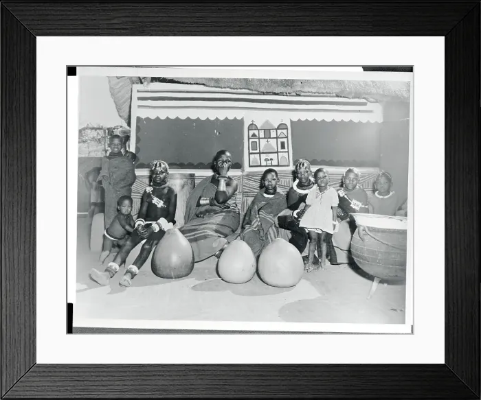 Framed Print : Woman and Children Sitting in Front of a Hut Framed Print : Woman and Children Sitting in Front of a Hut