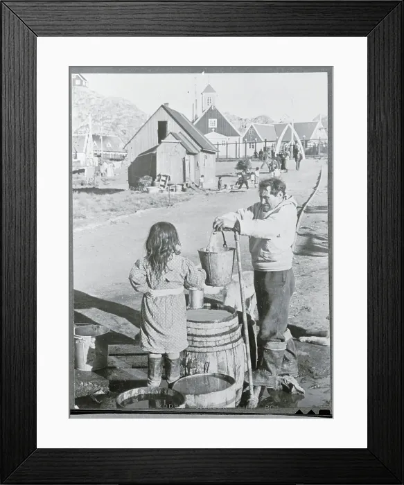 Framed Print : Man Getting Water From a Pipe Framed Print : Man Getting Water From a Pipe