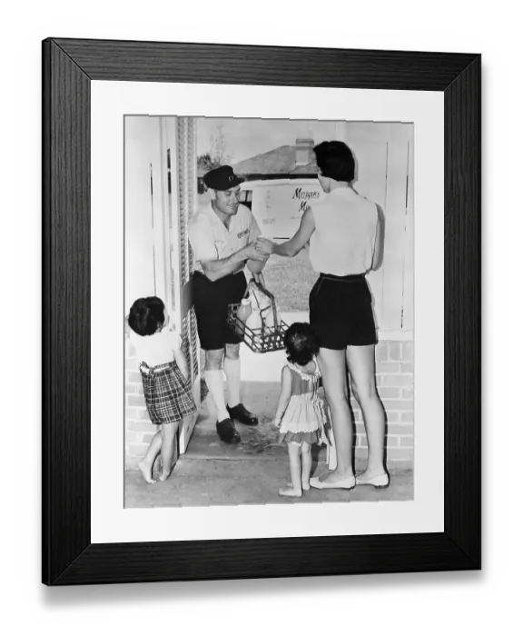 Framed Print : Mother with two children (3-4 years) paying milkman in doorway Framed Print : Mother with two children (3-4 years) paying milkman in doorway