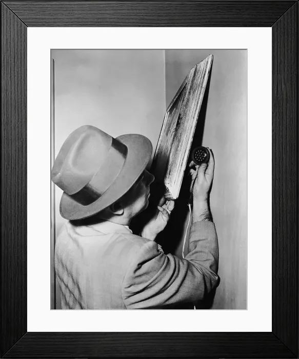 Framed Print : Man Placing Eavesdropping Device Behind Painting Framed Print : Man Placing Eavesdropping Device Behind Painting