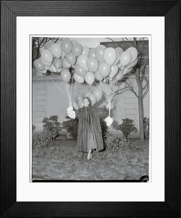 Framed Print : Odette Laure Holding Cluster of Balloons Framed Print : Odette Laure Holding Cluster of Balloons