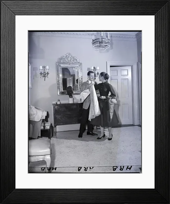 Framed Print : Man Helps Woman On With Coat Framed Print : Man Helps Woman On With Coat