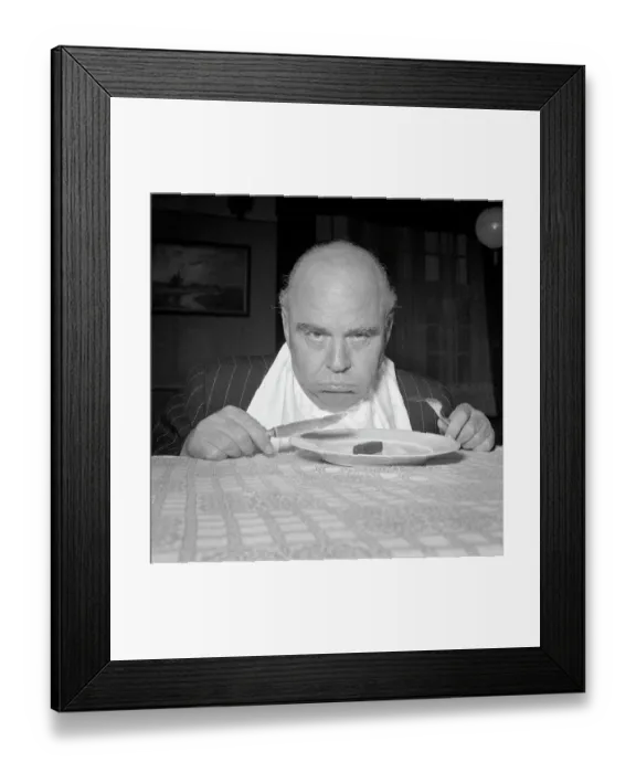 Framed Print : Pouting Man with Tiny Breakfast Framed Print : Pouting Man with Tiny Breakfast
