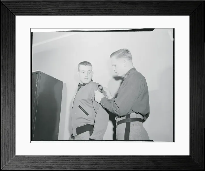 Framed Print : Robert Ferris Helping Pete Vann with Shoulder Patch
