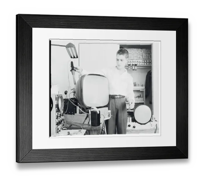 Framed Print : Boy Repairing a TV Framed Print : Boy Repairing a TV