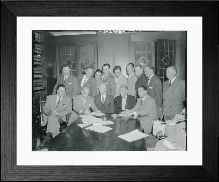 Framed Print : Businessmen Signing an Agreement Framed Print : Businessmen Signing an Agreement