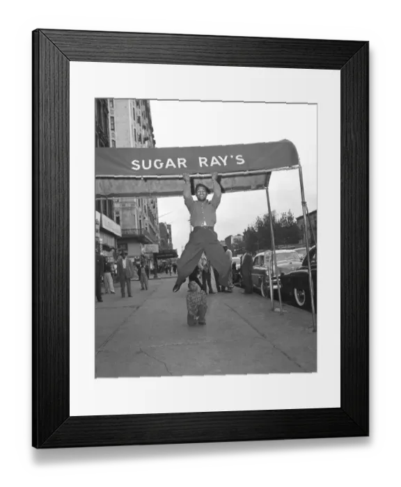 Framed Print : Sugar Ray Robinson Hanging From a Awning Framed Print : Sugar Ray Robinson Hanging From a Awning
