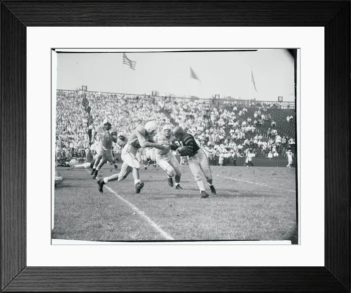 Framed Print : Football Players Tackling an Opponent Framed Print : Football Players Tackling an Opponent