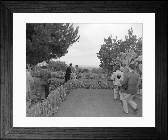 Framed Print : Audrey Hepburn and Mel Ferrer Running From Photographers