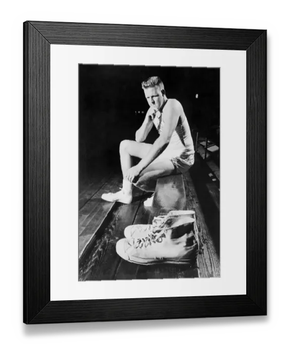 Framed Print : Clyde Lovelette Looking at a Pair of Shoes