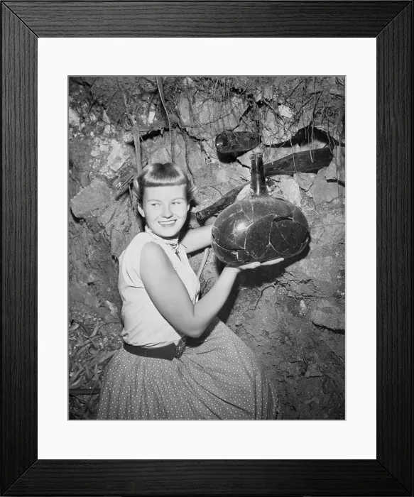 Framed Print : Woman Holding Unearthed Bottle Framed Print : Woman Holding Unearthed Bottle