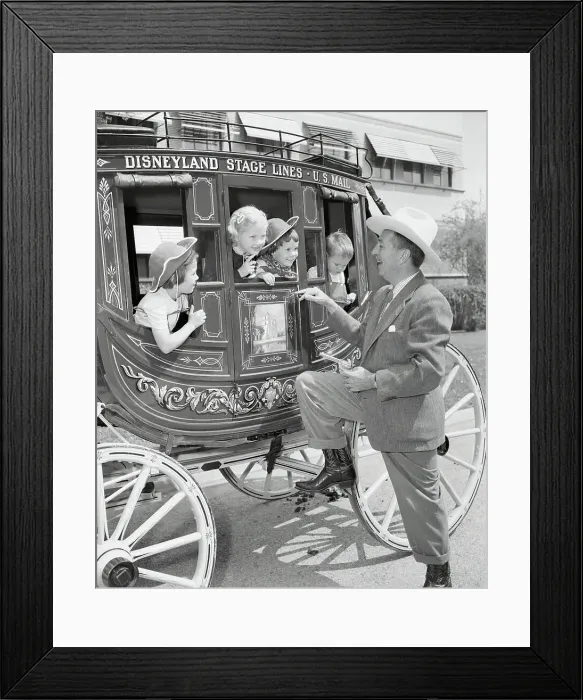 Framed Print : Walt Disney Holding Up Stagecoach Full of Children Framed Print : Walt Disney Holding Up Stagecoach Full of Children