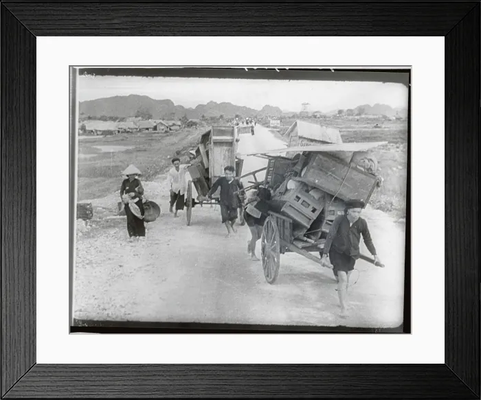 Framed Print : Villagers Pushing Carts in Flight Framed Print : Villagers Pushing Carts in Flight