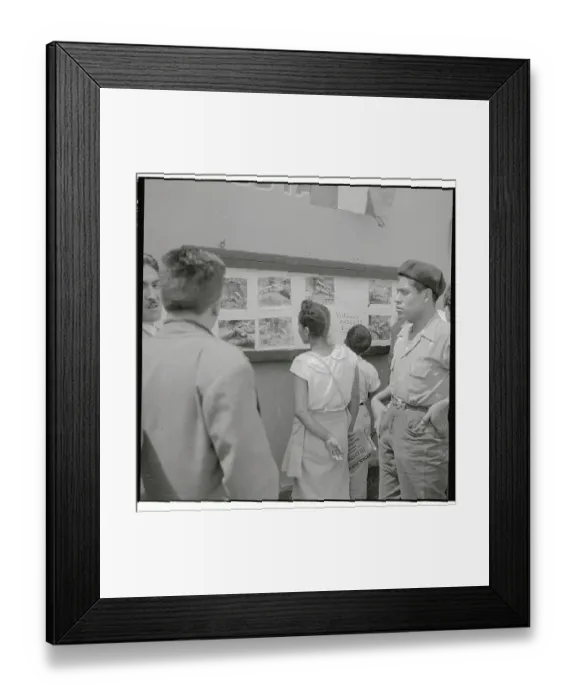 Framed Print : Group Looking at Photos on Wall Framed Print : Group Looking at Photos on Wall