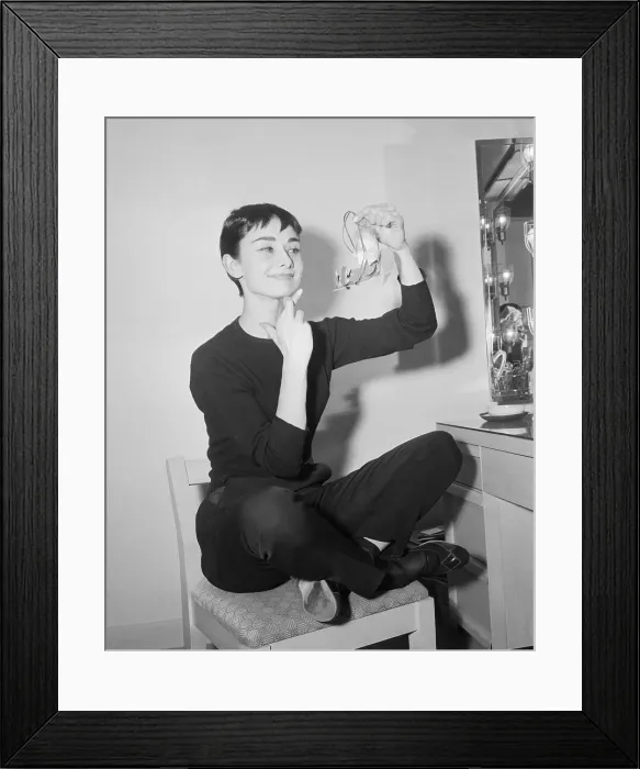 Framed Print : Audrey Hepburn with Fingers Crossed Holding an Angel Framed Print : Audrey Hepburn with Fingers Crossed Holding an Angel