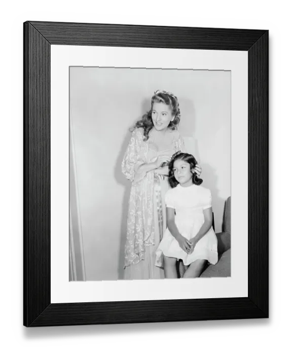 Framed Print : Joan Fontaine Combing Daughter's Hair Framed Print : Joan Fontaine Combing Daughter's Hair