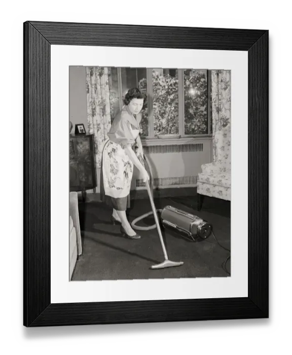 Framed Print : Woman Vacuuming Carpet Framed Print : Woman Vacuuming Carpet