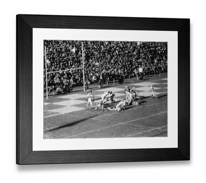 Framed Print : Football Players Tackling an Opponent Framed Print : Football Players Tackling an Opponent