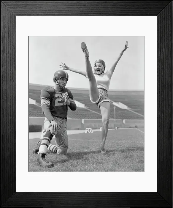 Framed Print : Mamie Van Doren Kicking on Football Field with Jim Sears Framed Print : Mamie Van Doren Kicking on Football Field with Jim Sears