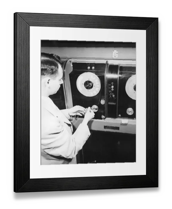Framed Print : Man Loading Tape Into Early Computer Framed Print : Man Loading Tape Into Early Computer