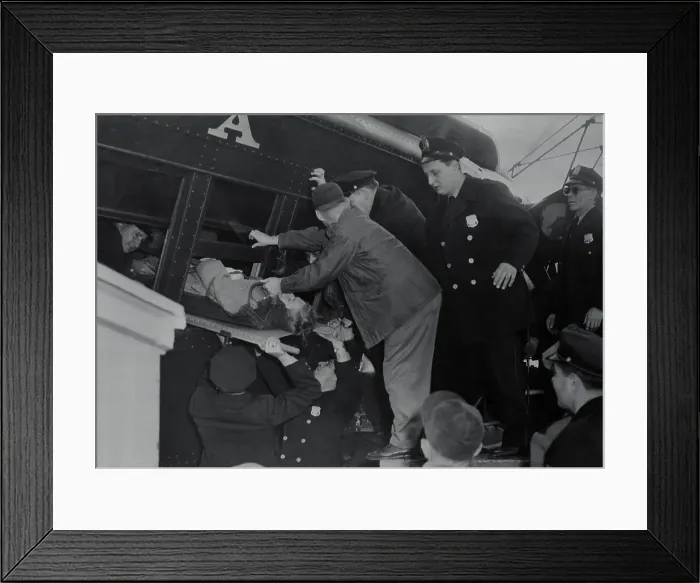 Framed Print : Workers Removing Injured Victim Framed Print : Workers Removing Injured Victim