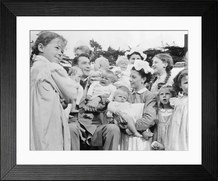 Framed Print : Gregory Peck Kissing Babies Framed Print : Gregory Peck Kissing Babies