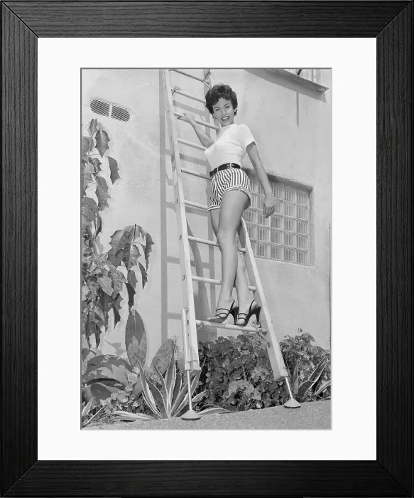 Framed Print : Rita Moreno Posing on Non-Slip Ladder Framed Print : Rita Moreno Posing on Non-Slip Ladder
