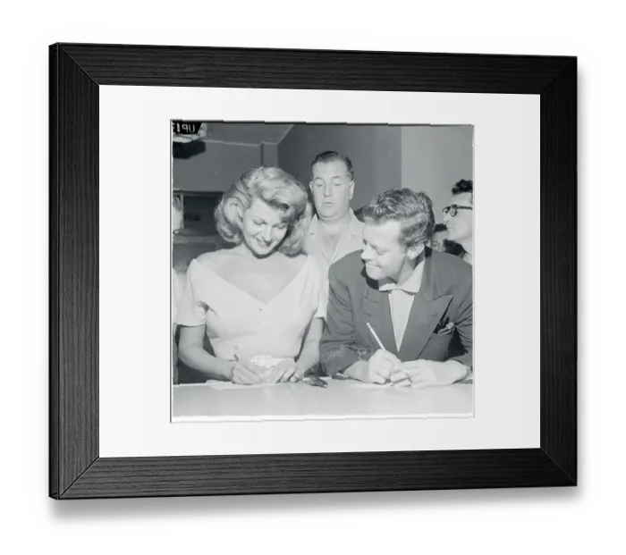 Framed Print : Dick Haymes and Jack Entratter Watching Rita Hayworth Sign