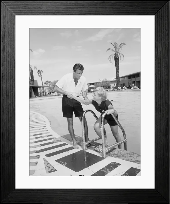 Framed Print : Peter Lawford Assisting Judy Holiday Poolside Framed Print : Peter Lawford Assisting Judy Holiday Poolside