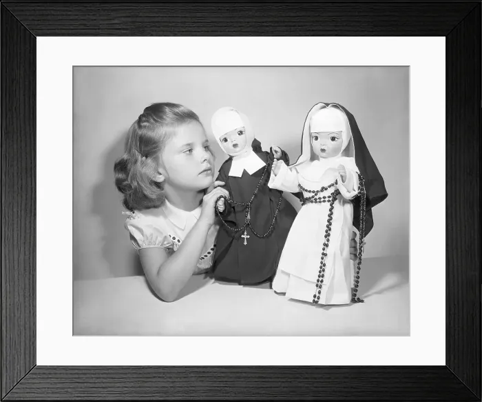 Framed Print : Girl Playing with Nun Dolls