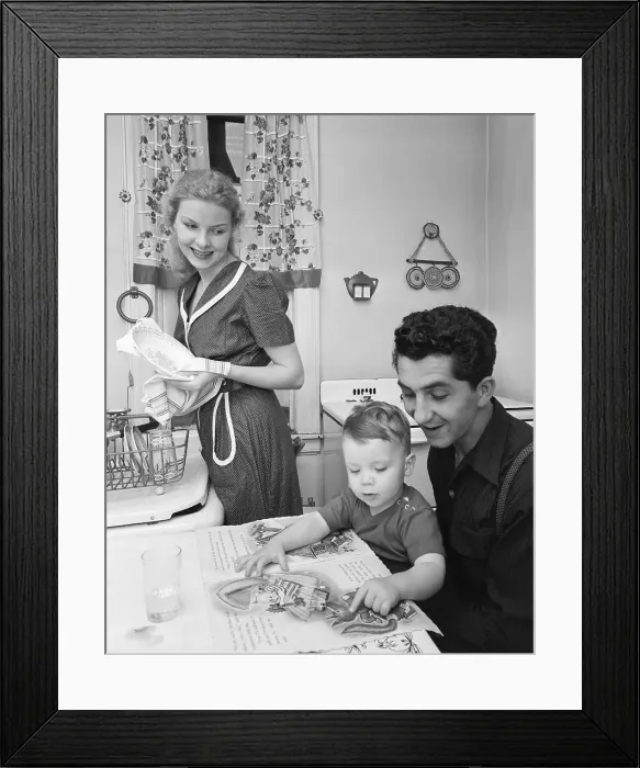 Framed Print : Woman Cookiing While Man Reads To Son Framed Print : Woman Cookiing While Man Reads To Son