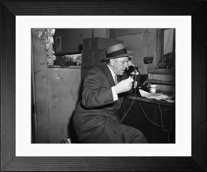 Framed Print : Bob Considine Sitting and Talking on Phone