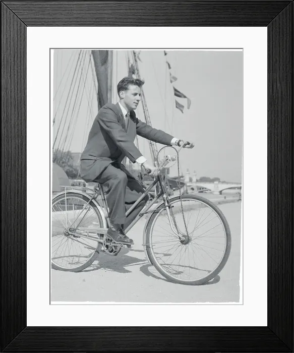 Framed Print : Charles Duval on His Invented Bicycle near Boat Dock Framed Print : Charles Duval on His Invented Bicycle near Boat Dock