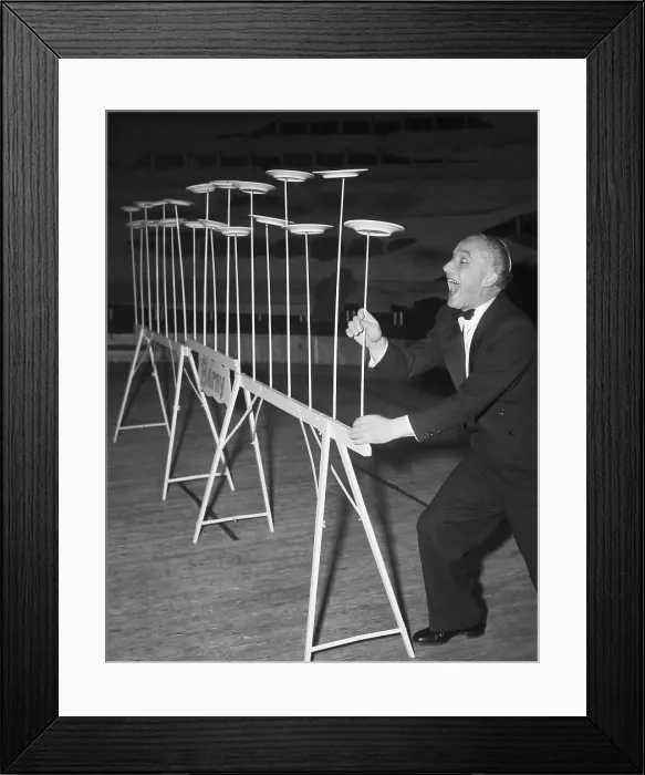 Framed Print : German Juggler Balances Plates On Sticks Framed Print : German Juggler Balances Plates On Sticks