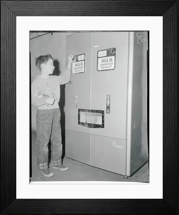 Framed Print : John Herley Inserting Coin