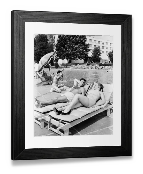 Framed Print : Couple Sunbathing Poolside Framed Print : Couple Sunbathing Poolside