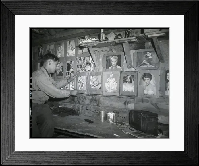 Framed Print : Soldier Putting Picture On Pinup Wall Framed Print : Soldier Putting Picture On Pinup Wall