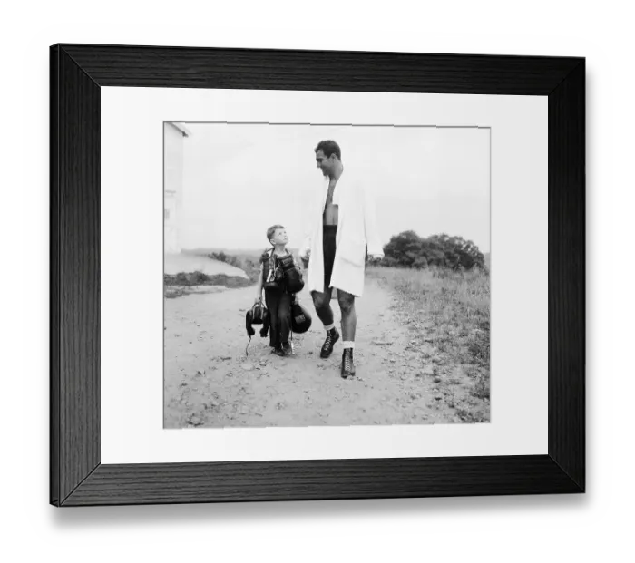 Framed Print : Rocky Marciano with Boy Carrying His Gear Framed Print : Rocky Marciano with Boy Carrying His Gear