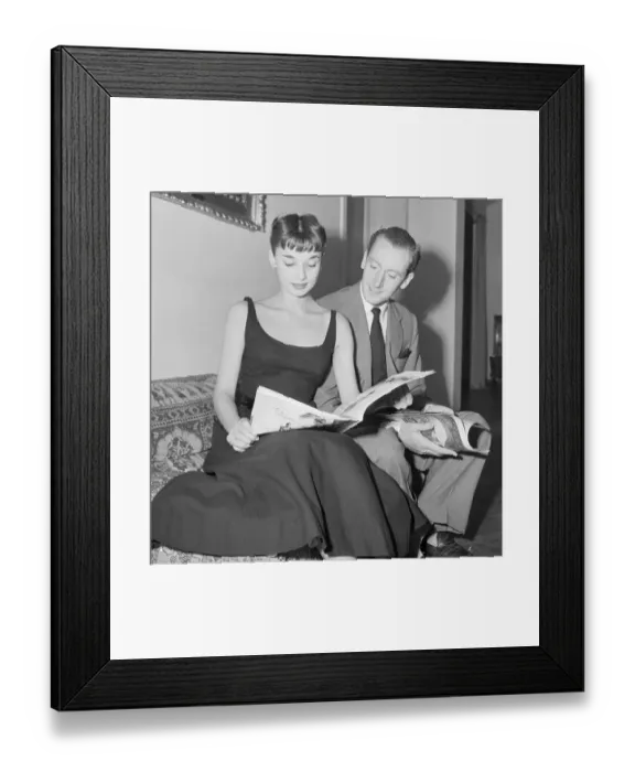 Framed Print : Audrey Hepburn and James Hanson Reading Magazines Framed Print : Audrey Hepburn and James Hanson Reading Magazines