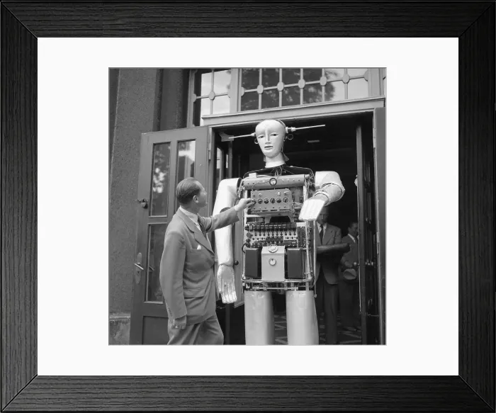 Framed Print : Man Adjusting Louie the Robot Framed Print : Man Adjusting Louie the Robot