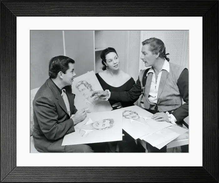 Framed Print : Errol Flynn, Mil Patrick, and Bud Westmore Discussing Sketches Framed Print : Errol Flynn, Mil Patrick, and Bud Westmore Discussing Sketches