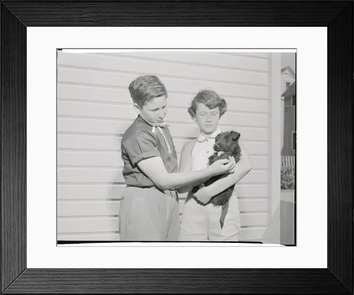 Framed Print : Youngsters Holding Black Scottie Pup Framed Print : Youngsters Holding Black Scottie Pup