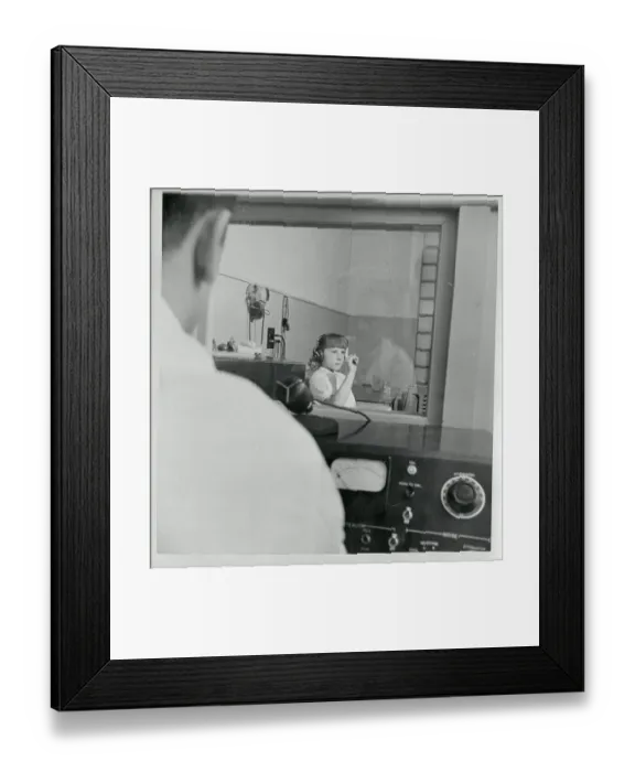 Framed Print : Young Hearing Impaired Girl Gesturing from Soundproof Room Framed Print : Young Hearing Impaired Girl Gesturing from Soundproof Room
