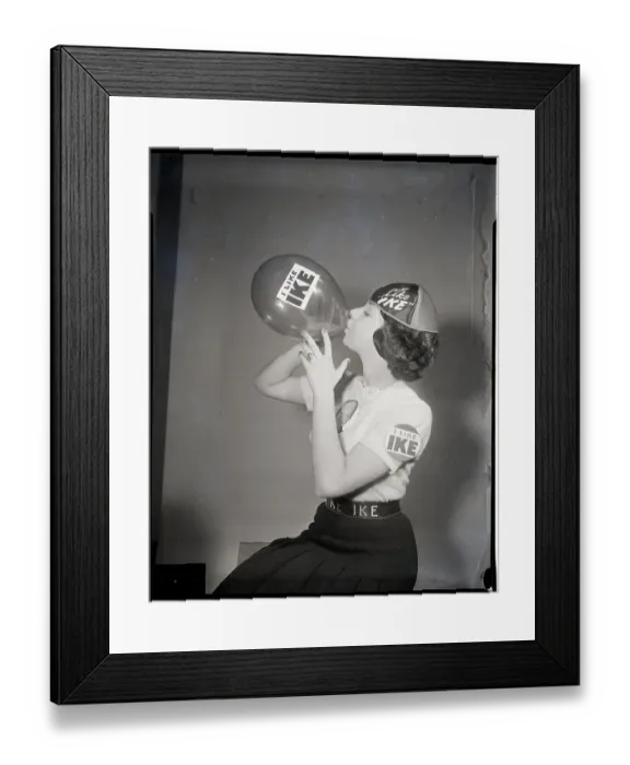 Framed Print : Girl Blows Up Balloon With Ike On It Framed Print : Girl Blows Up Balloon With Ike On It