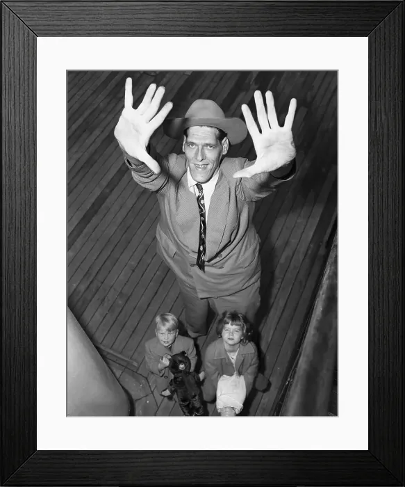 Framed Print : Young Children Standing Under Giant Man Framed Print : Young Children Standing Under Giant Man