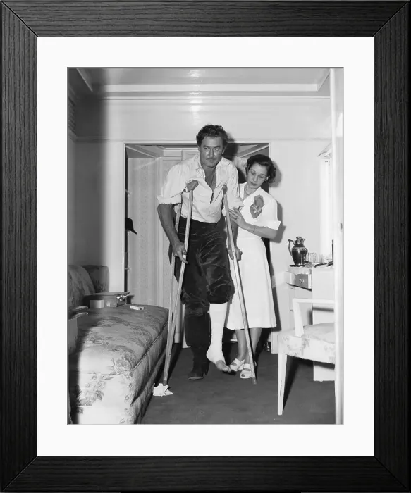 Framed Print : Nurse Visiting Errol Flynn on Crutches Framed Print : Nurse Visiting Errol Flynn on Crutches