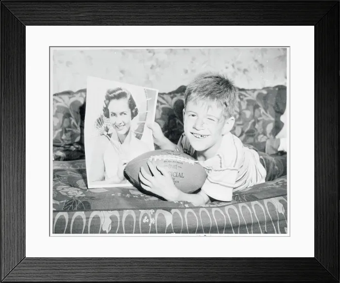 Framed Print : Boy Holding Football and Photo of Debbie Reynolds
