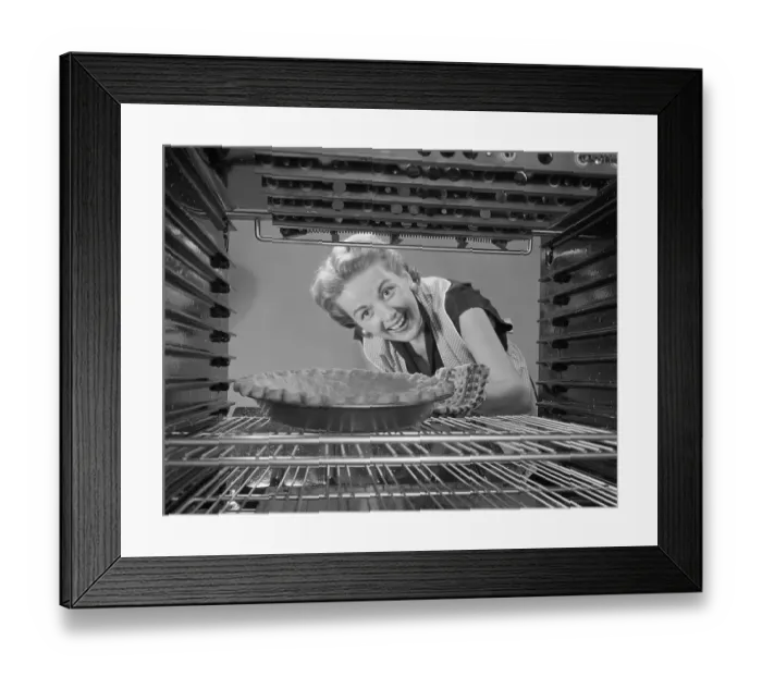Framed Print : Woman Looking at Pie in Oven Framed Print : Woman Looking at Pie in Oven