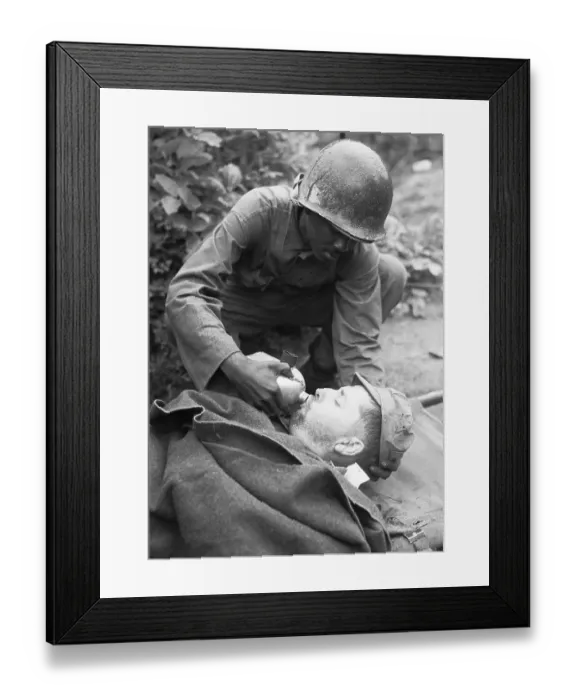 Framed Print : Medic Lowers Canteen To Lips Of Soldier